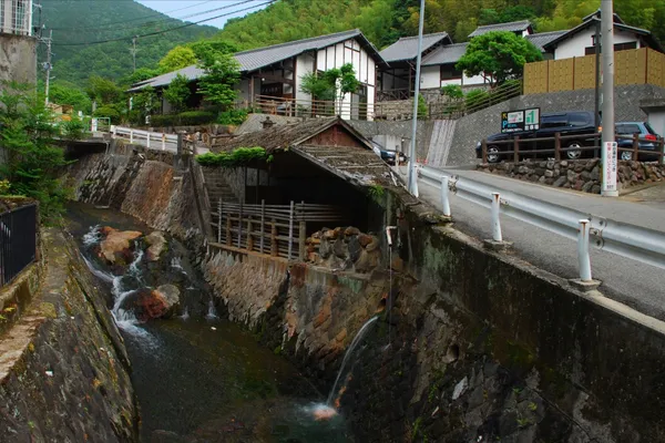 渓谷に包まれた柴石温泉の建物と流れ